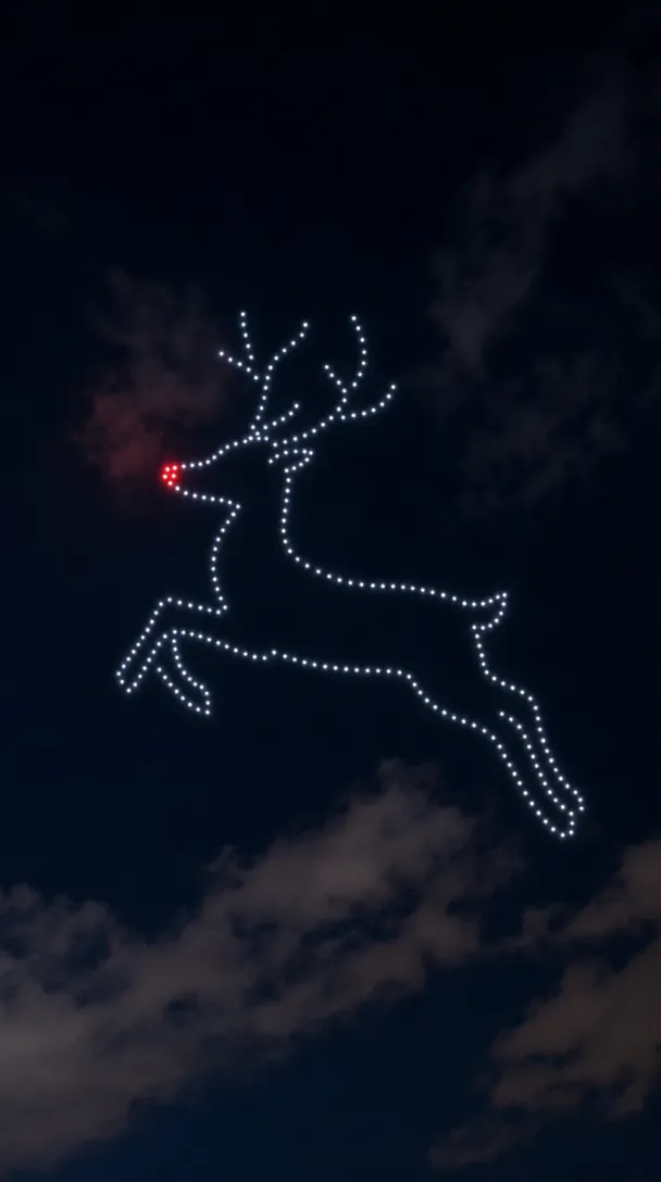 Drones forming a leaping reindeer with a glowing red nose